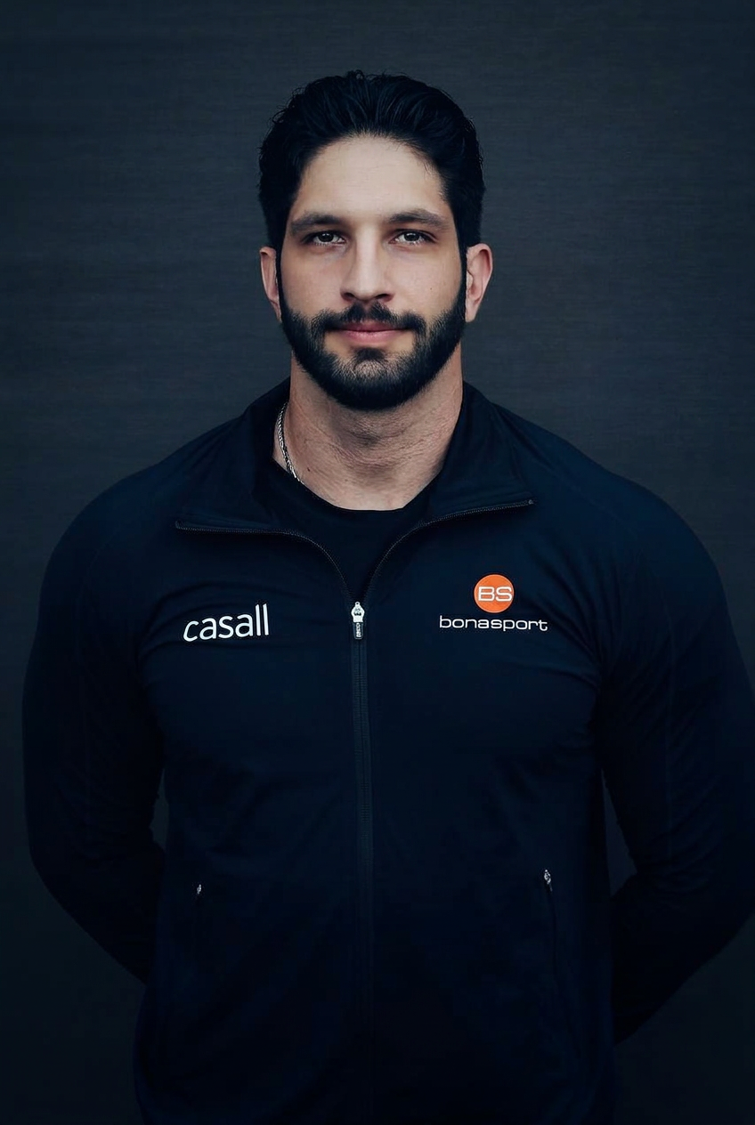 Portrait placeholder of the performance coach in a low-light gym